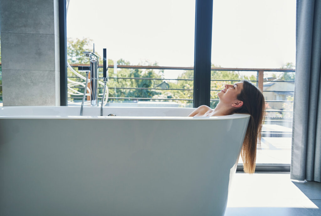Happy lady is taking bath in morning